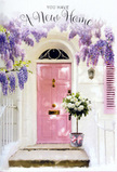 A welcoming Archway doorway is captured at the very moment flowers turn a simple entrance into a memory. At the centre is a painted pink door, its pastel surface smooth and subtly luminous, framed by whitewashed walls that bounce the light back in soft, creamy tones. Overhead, cascades of lavender wisteria drape down in abundant clusters, their bell-shaped blooms forming a delicate curtain that suggests both shelter and celebration. The wisteria's twisting stems and leaves create a natural arch, the kind you might notice on a stroll through the more hidden residential corners of Archway, where vines are lovingly trained around doorways and balconies. Sitting proudly on the doorstep is a stylish metal bucket, a cool grey-silver in colour, filled to overflowing with white and cream roses. The roses are generously petalled and velvety, some just opening, others fully unfurled, showing soft spirals of ivory at their centres. Sprigs of gentle green foliage nestle between them, lending movement and a hint of countryside freshness. A pale pink ribbon is tied around the base of the bucket, its loose, trailing ends resting lightly against the step and mirroring the tone of the door. The overall effect is one of serene joy: pastel colours, trailing blooms, and rich textures uniting to evoke the feeling of a housewarming bouquet just delivered by a local Archway florist. It's a scene rich with scent, quiet excitement, and the tender promise that this doorway will soon witness laughter, shared meals, and many happy returns home.